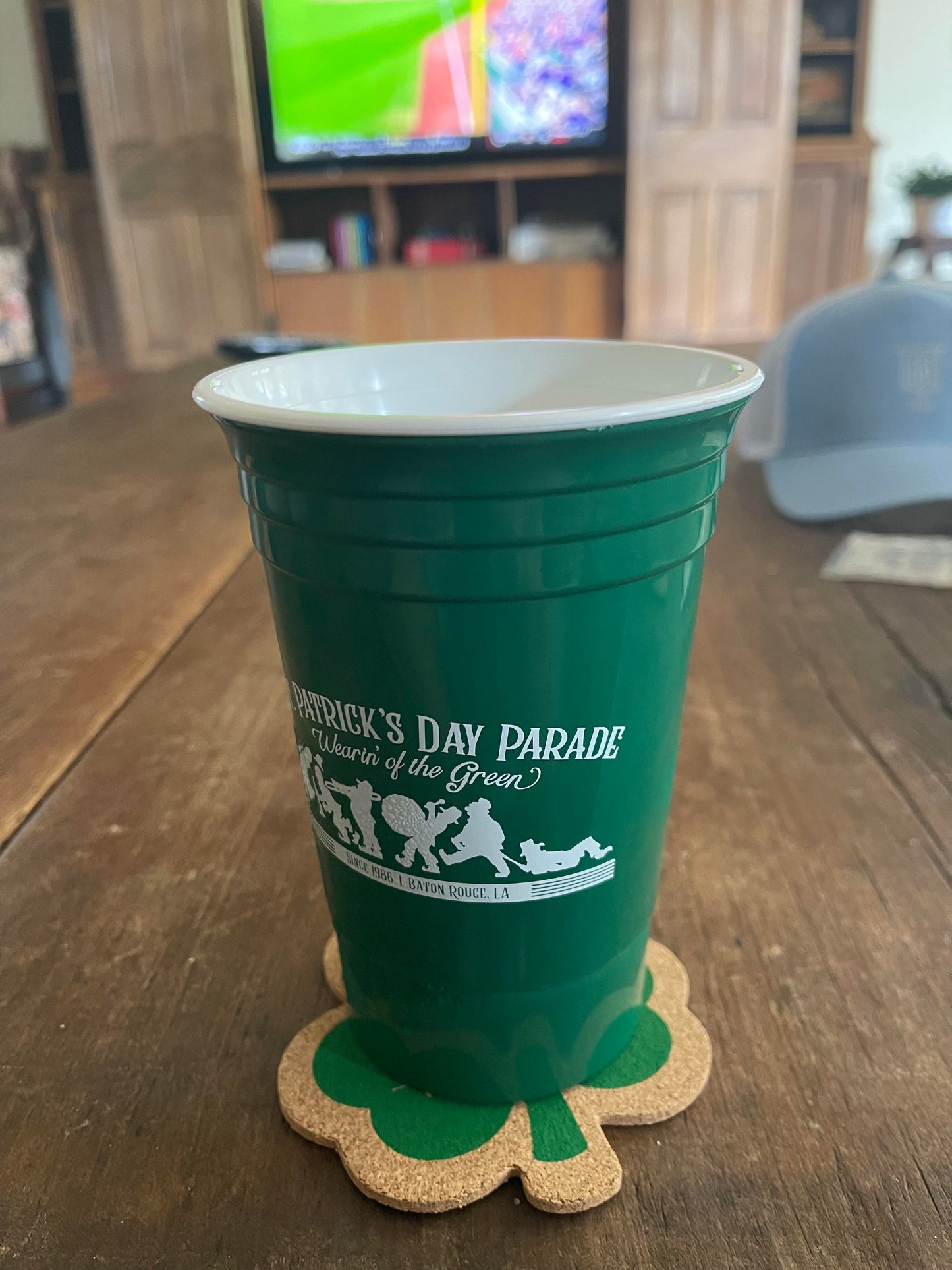 Parade cup sitting atop a shamrock coaster.